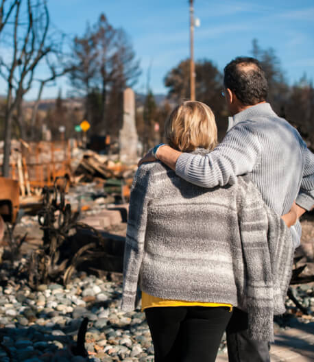 Man and his wife owners, checking burned home